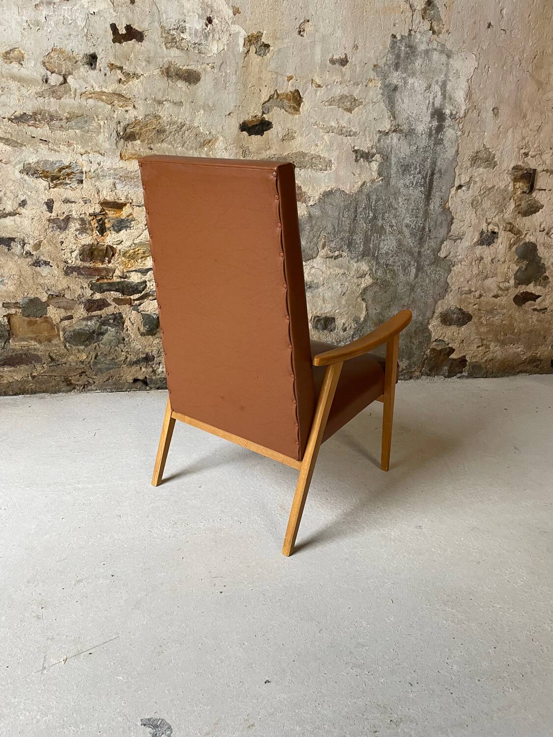 Vintage armchair in wood and brown faux leather