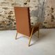 Vintage armchair in wood and brown faux leather