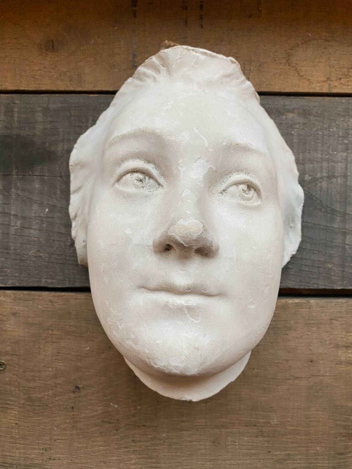 Plaster face wall statue
