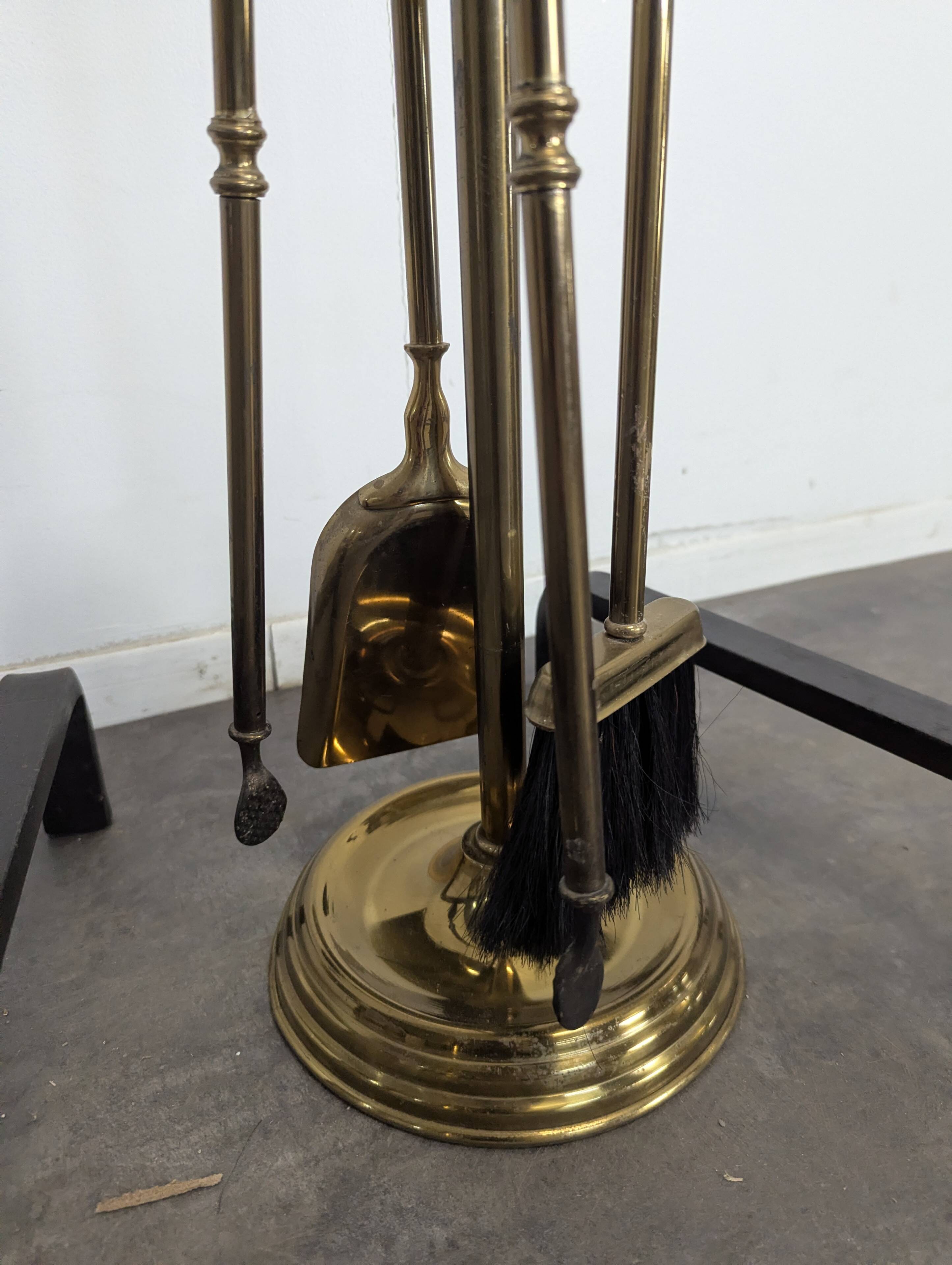 Pair of fire dogs and fireplace tools