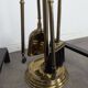 Pair of fire dogs and fireplace tools