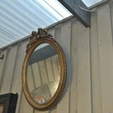 Louis XVI-style oval mirror in gilded stucco circa 1900