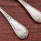 Christofle, Paris - Set of 2 table spoons - Crossed Ribbons model - in silver-plated metal