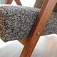 Vintage design armchair in mixed black fabric, walnut-coloured wood.