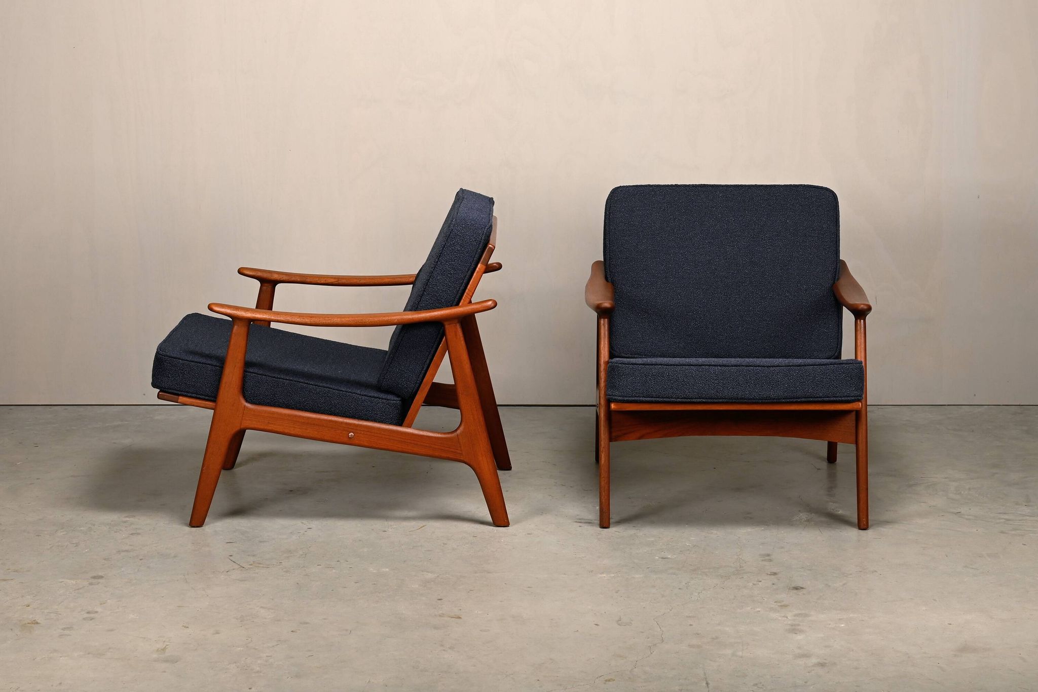 Pair Scandinavian Modern armchairs in teak and dark blue bouclé fabric