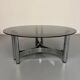 Round coffee table in smoked glass and chrome steel, 1970s design.
