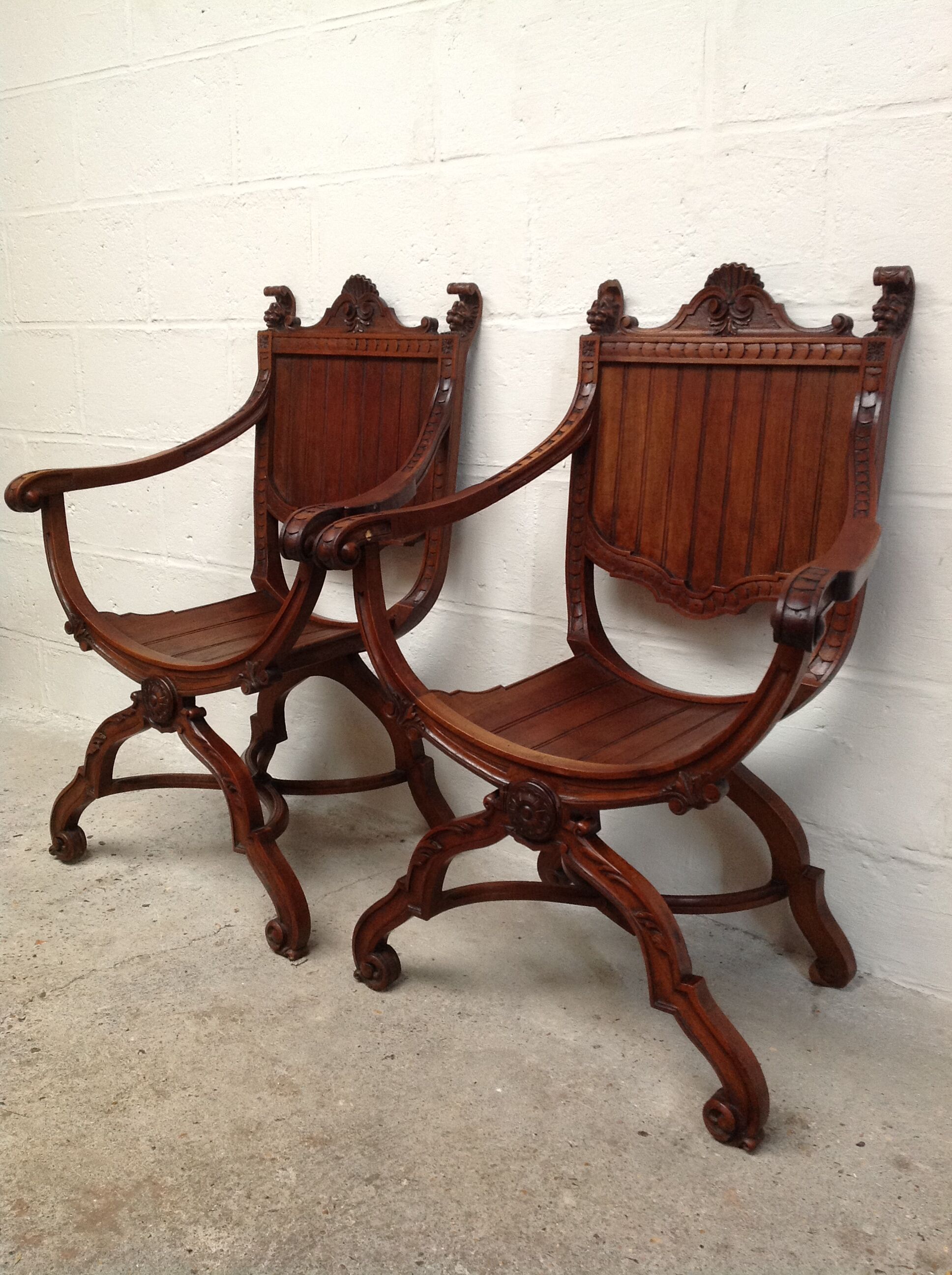 Pair of antique armchairs curules called Dagobert in carved wood