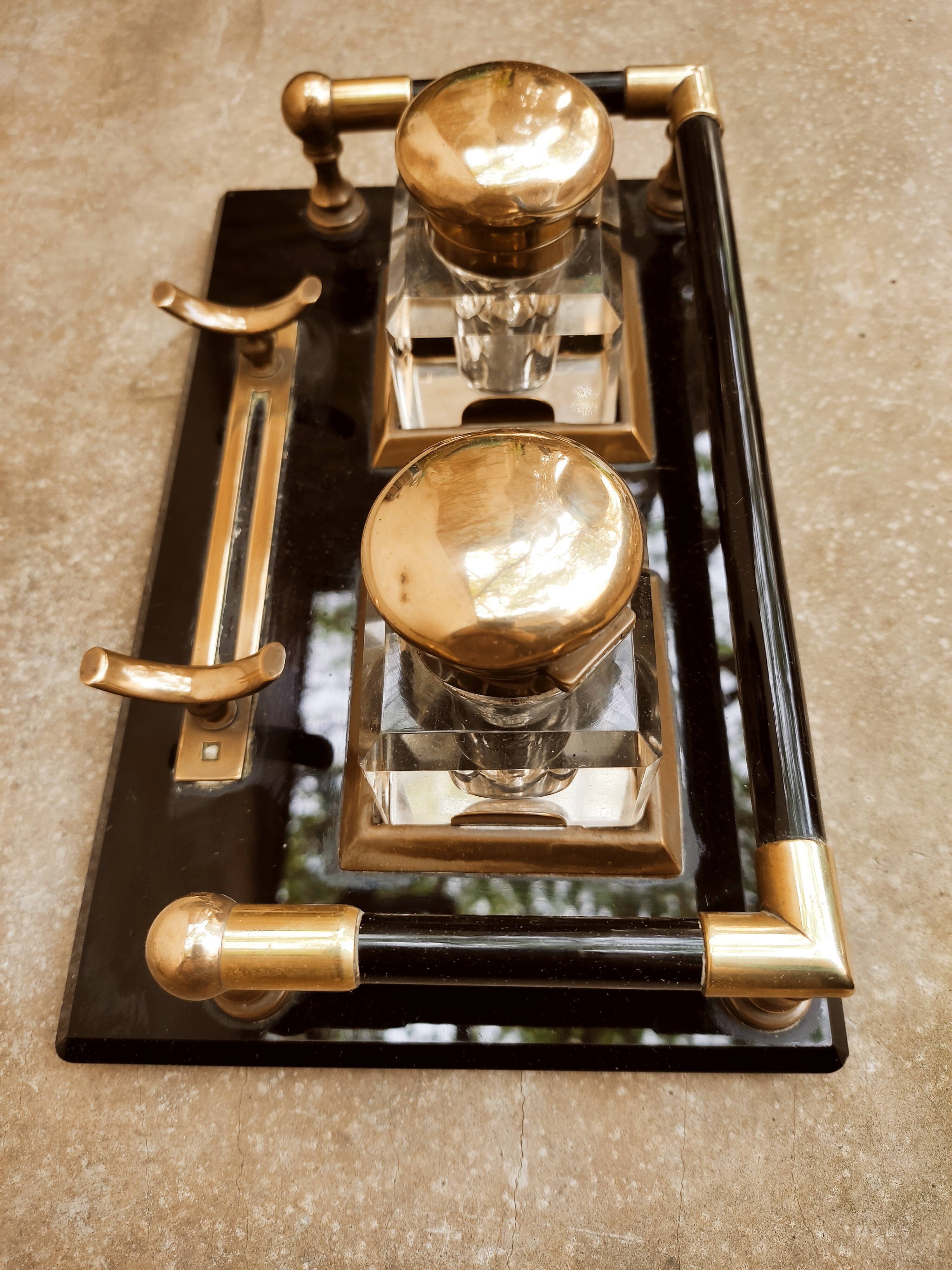 Hence the art deco inkwell on jet plate brass finishes