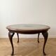 Louis XV coffee table in wood with decorative glass top.