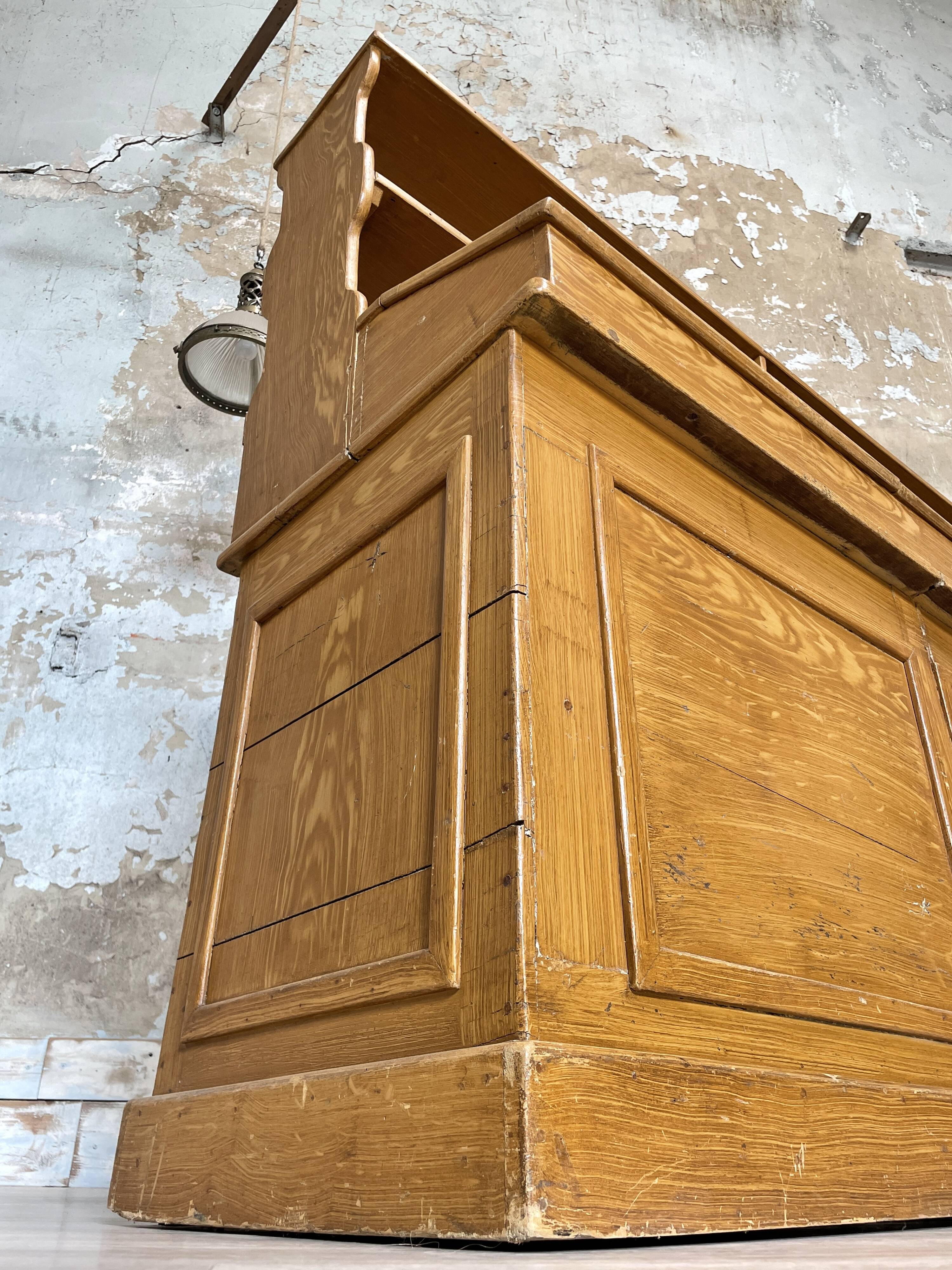 Wooden hardware cabinet painted with wood effect, circa 1940.