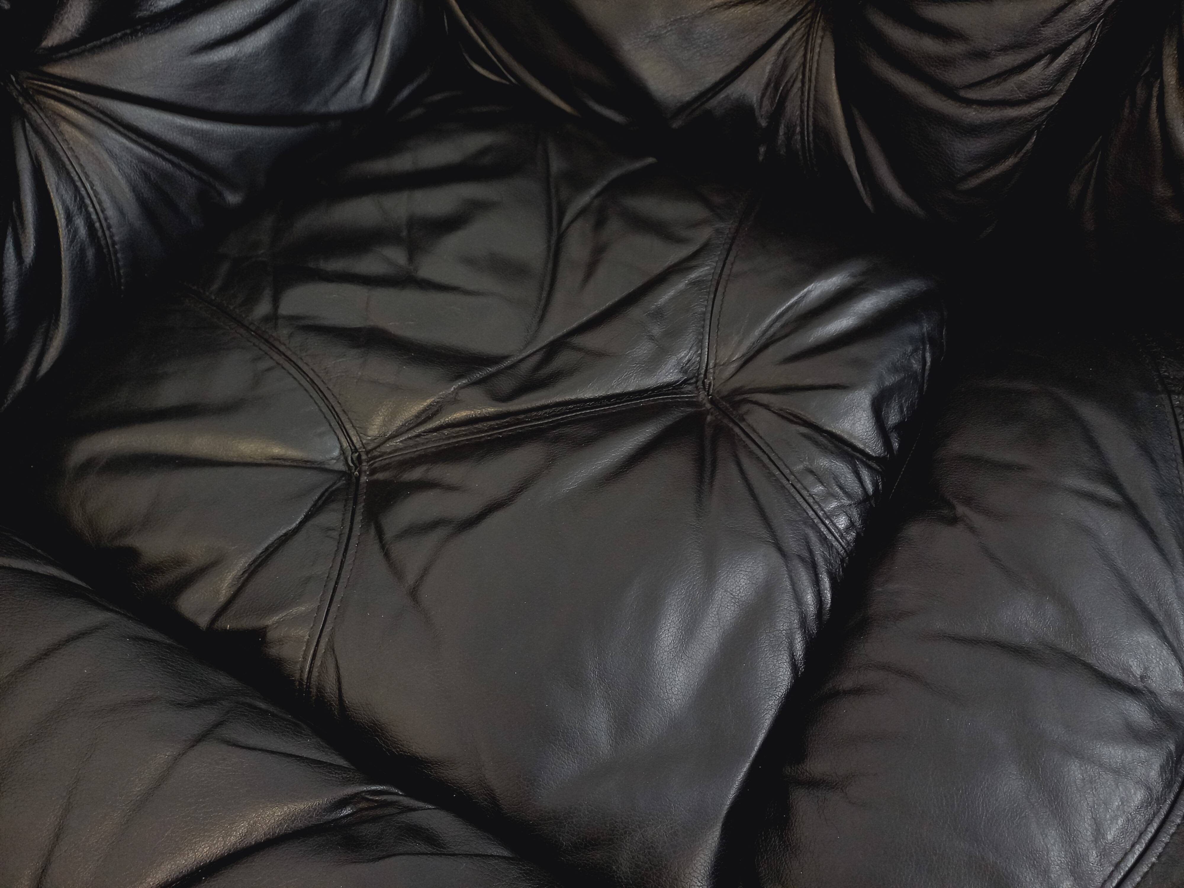 Vintage corner sofa composed of 3 modules in black leather with integrated bed.