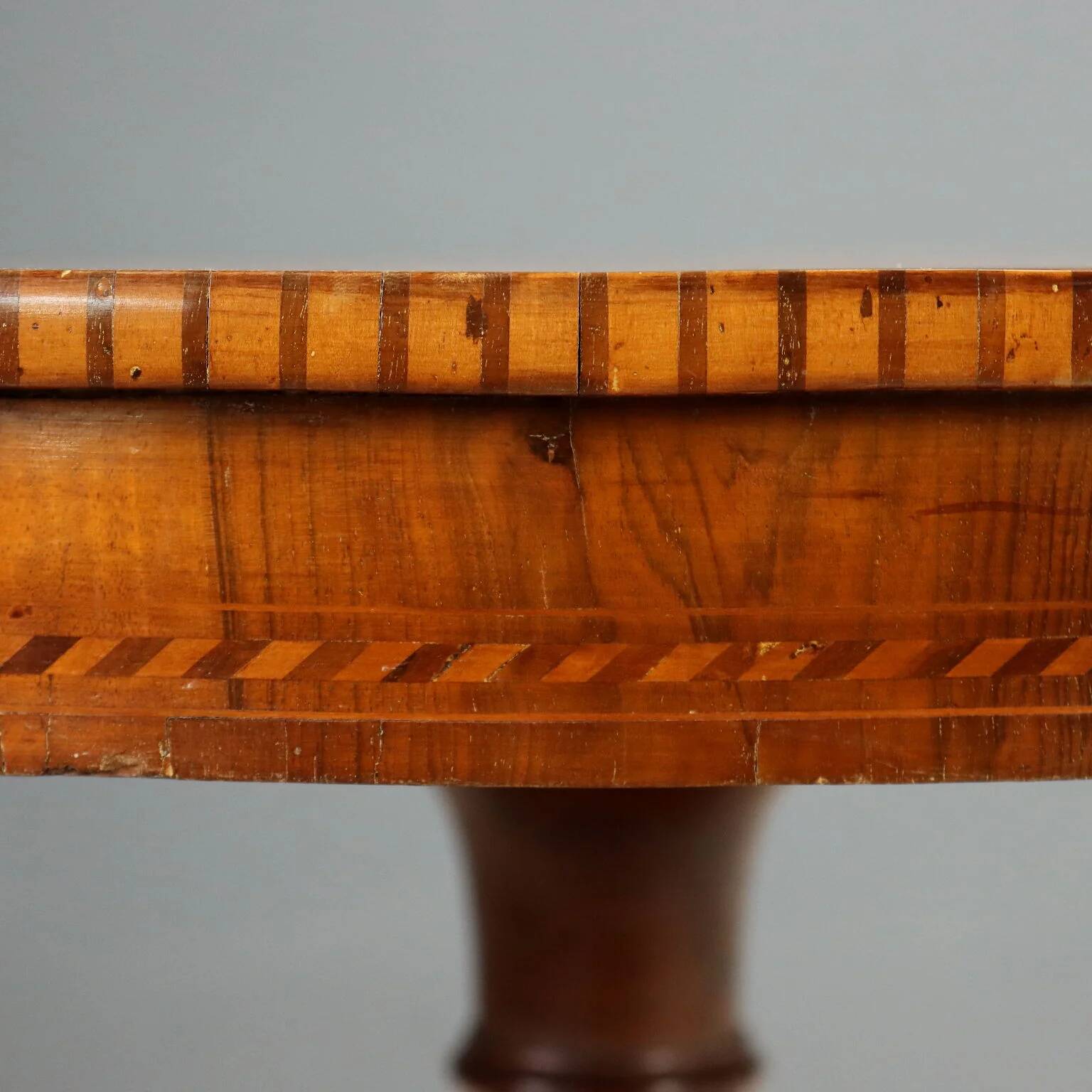 Antique round walnut table with a baluster central leg, Italy, 19th century.