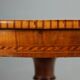 Antique round walnut table with a baluster central leg, Italy, 19th century.