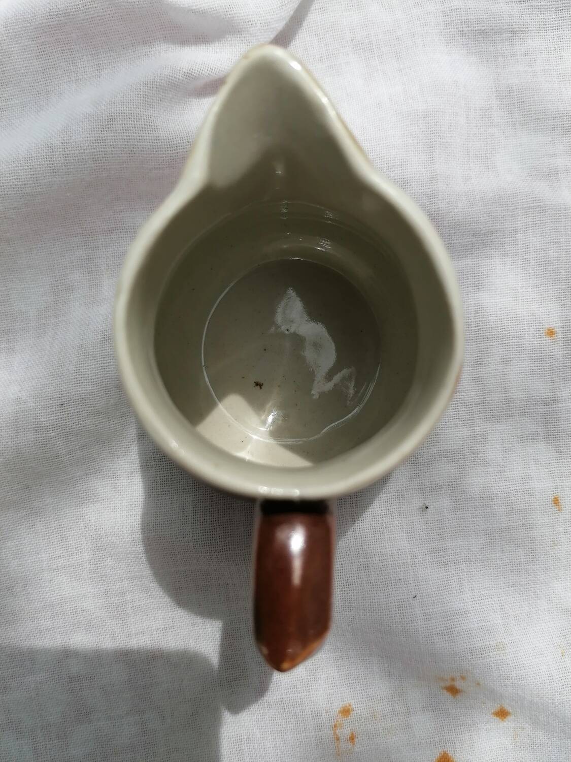 Brown ceramic teapot and milk jugs