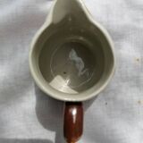 Brown ceramic teapot and milk jugs