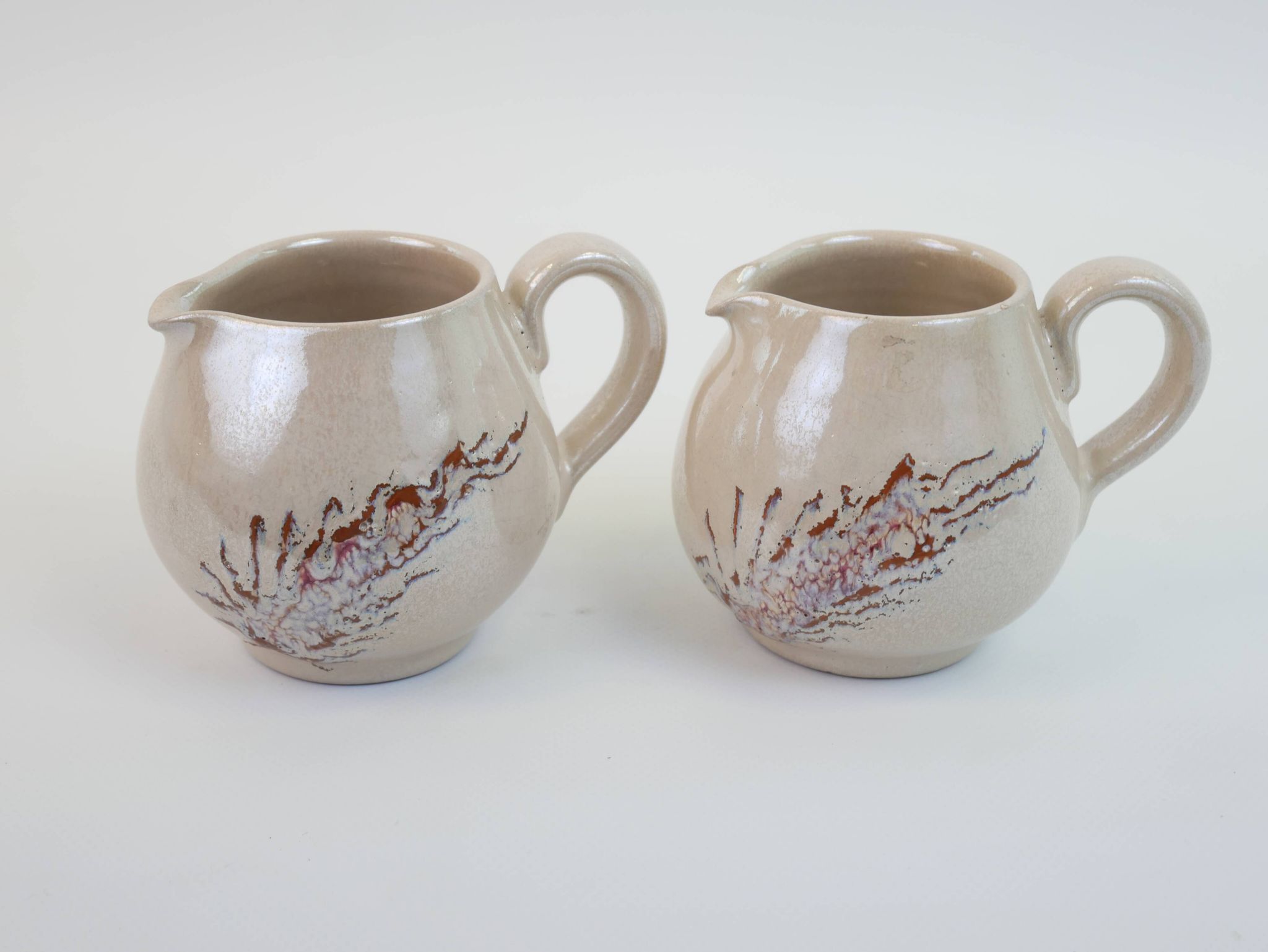 Pair of ceramic milk jugs signed La Roue Vallauris