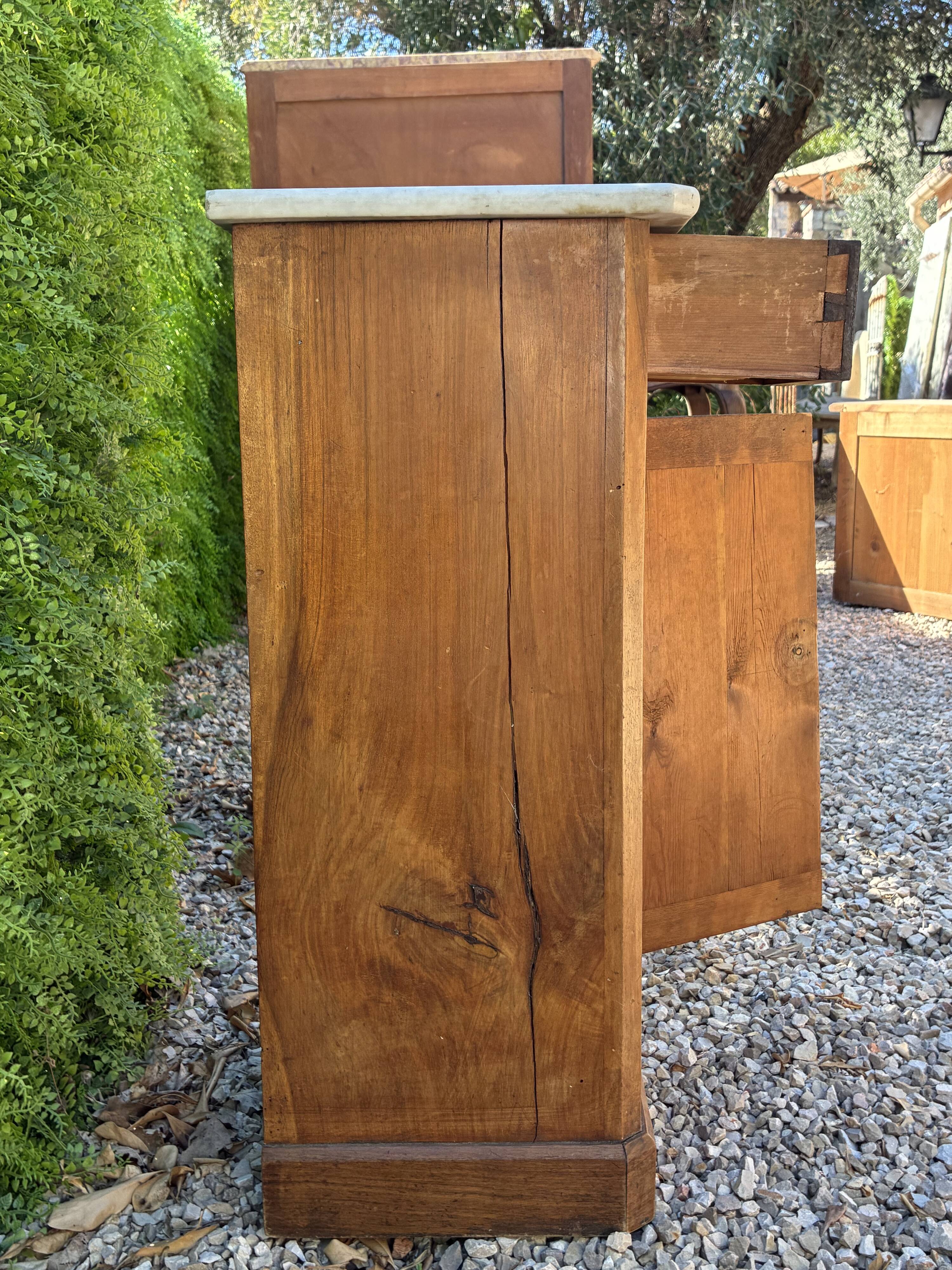 Antique wooden bedside table with marble
