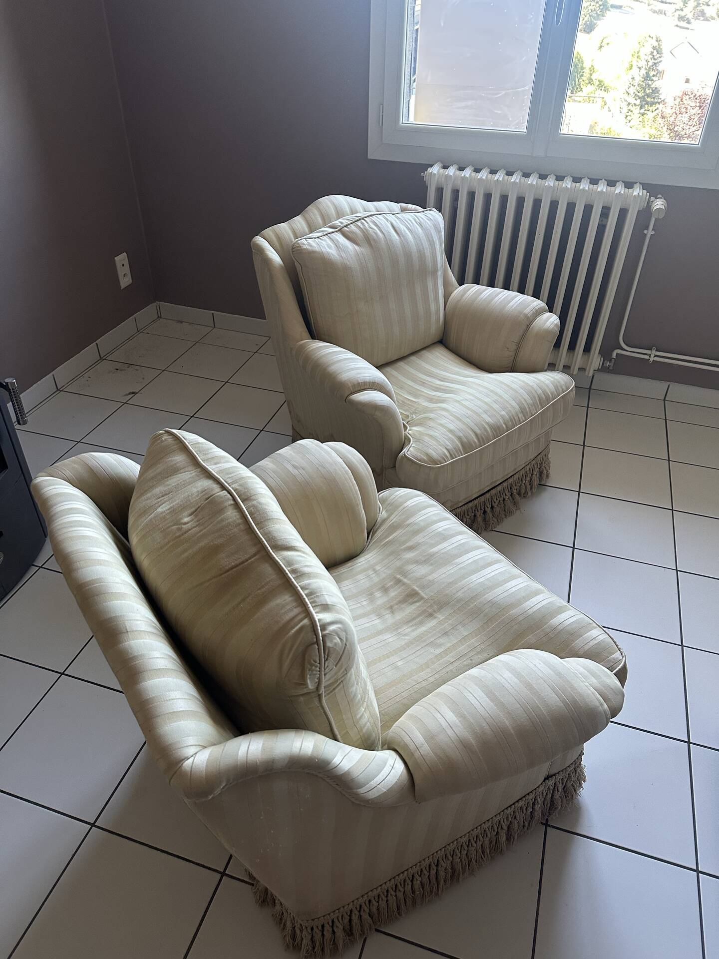 Pair of vintage bergère armchairs in striped ecru and beige fabric.