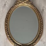 19th century oval gilded mirror, torch & quiver 106cm