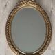 19th century oval gilded mirror, torch & quiver 106cm