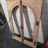 Old arched window made of fir wood