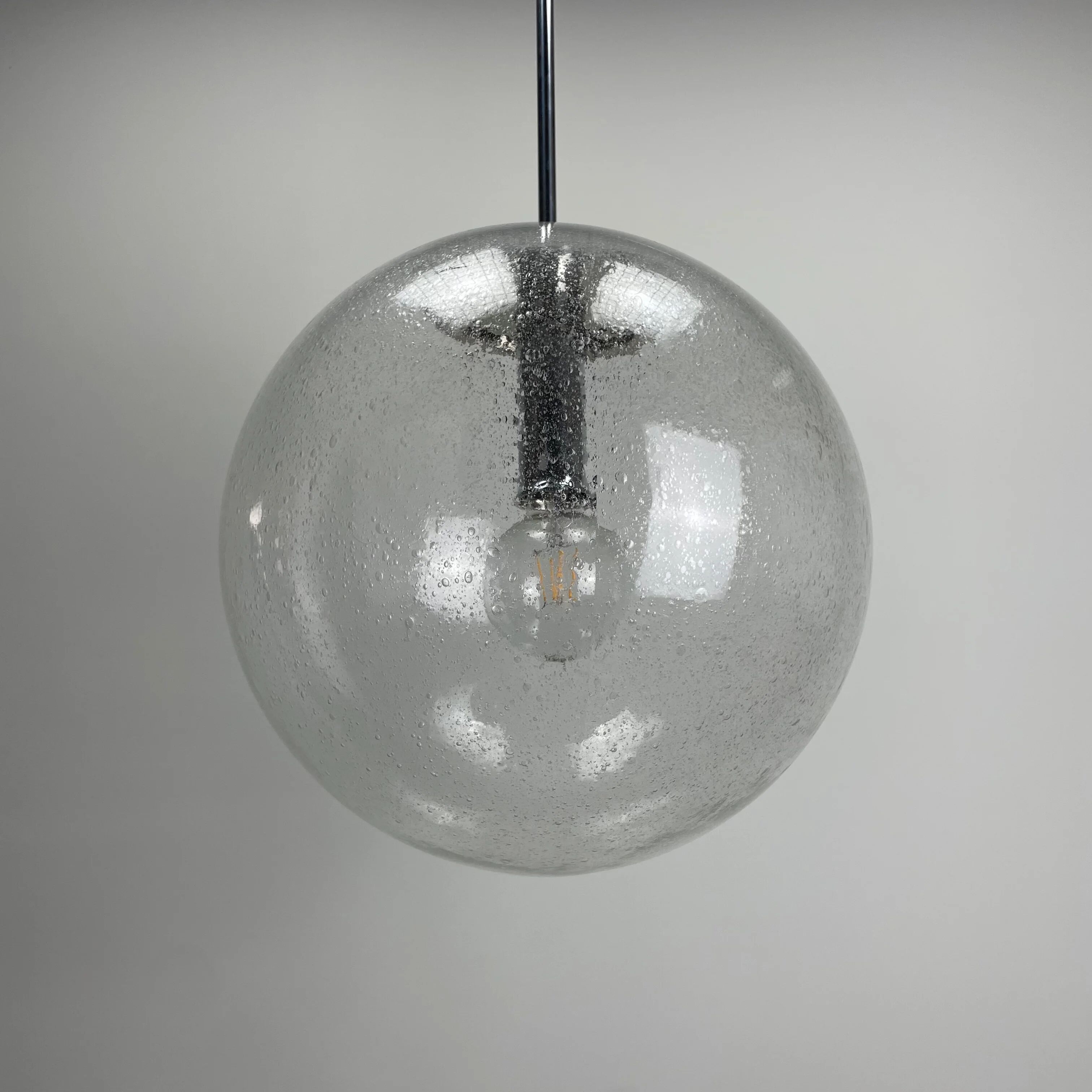 Large suspended lamp with a glass globe featuring bubbles by Peill & Putzler 1970.