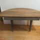 Antique painted wooden half-moon console table