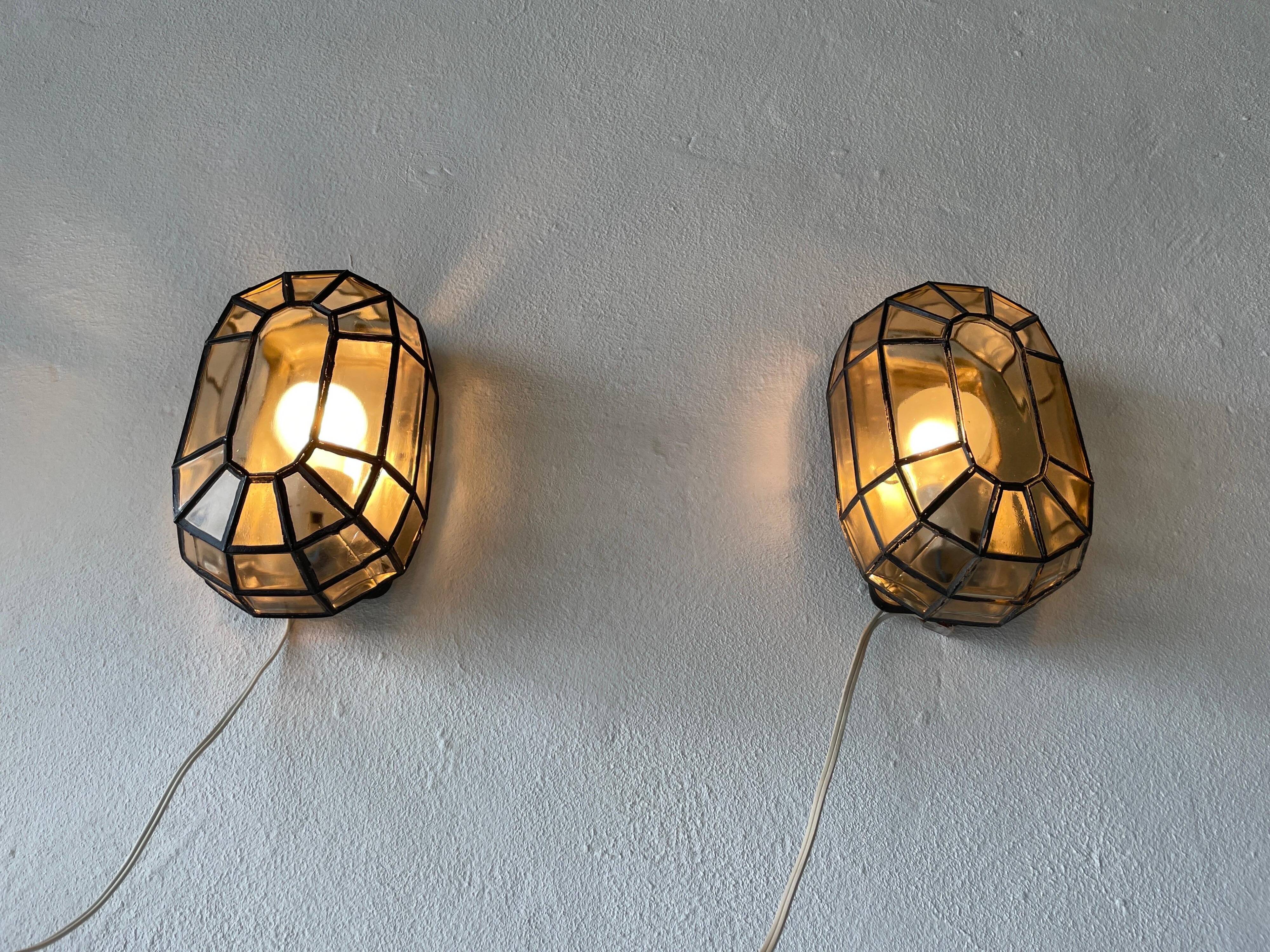 Pair of black iron wall sconces with structured glass by Limburg, 1960s, Germany.