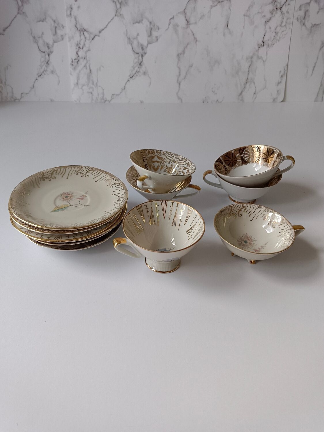 Set of mismatched fine porcelain cups signed with saucer