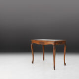 Side table with sculpted elements and rattan top