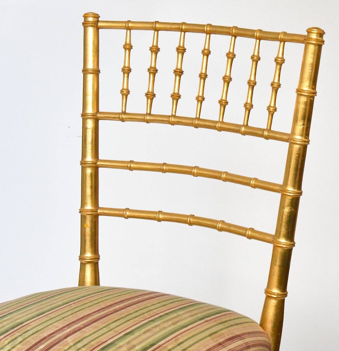 Pair of golden wood chairs in a bamboo style.