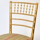 Pair of golden wood chairs in a bamboo style.