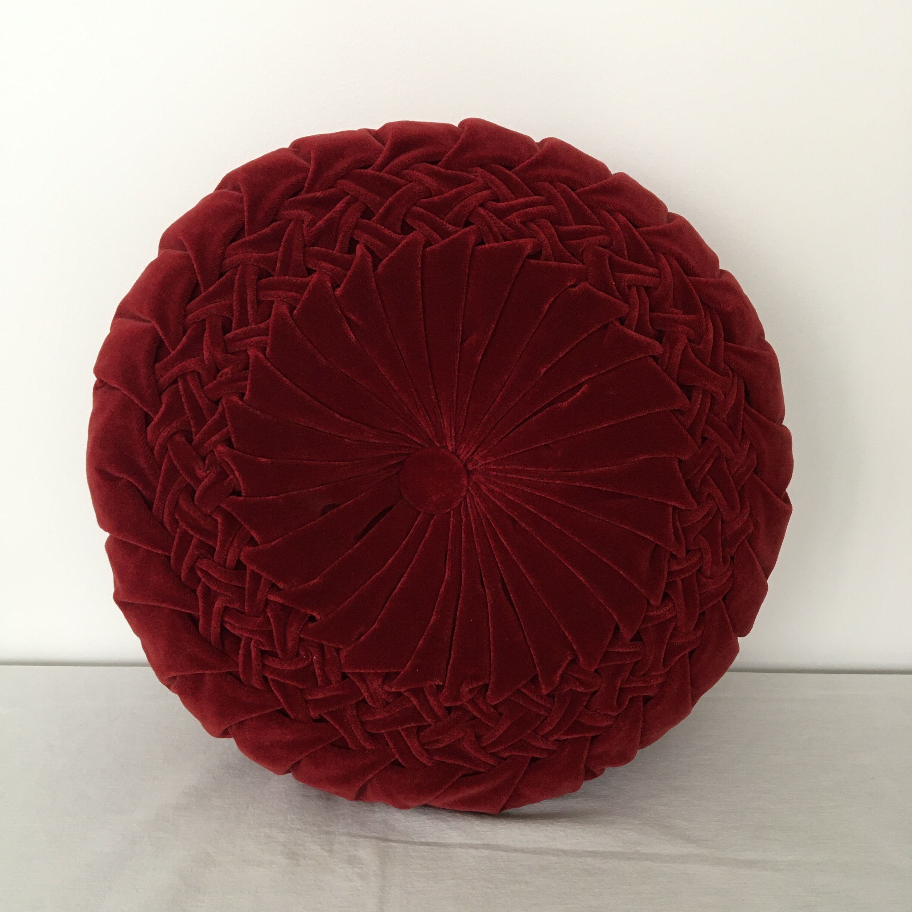 Folded velvet burgundy red round cushion