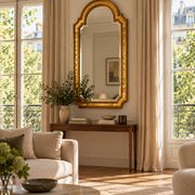 Florentine arched mirror in gilded wood with gold leaf.