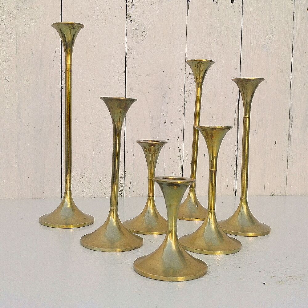 Seven candle holders in golden brass vintage trend