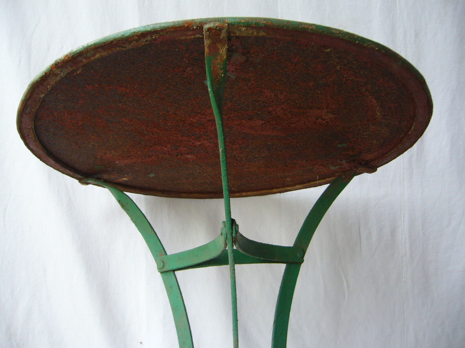 Old riveted metal garden pedestal