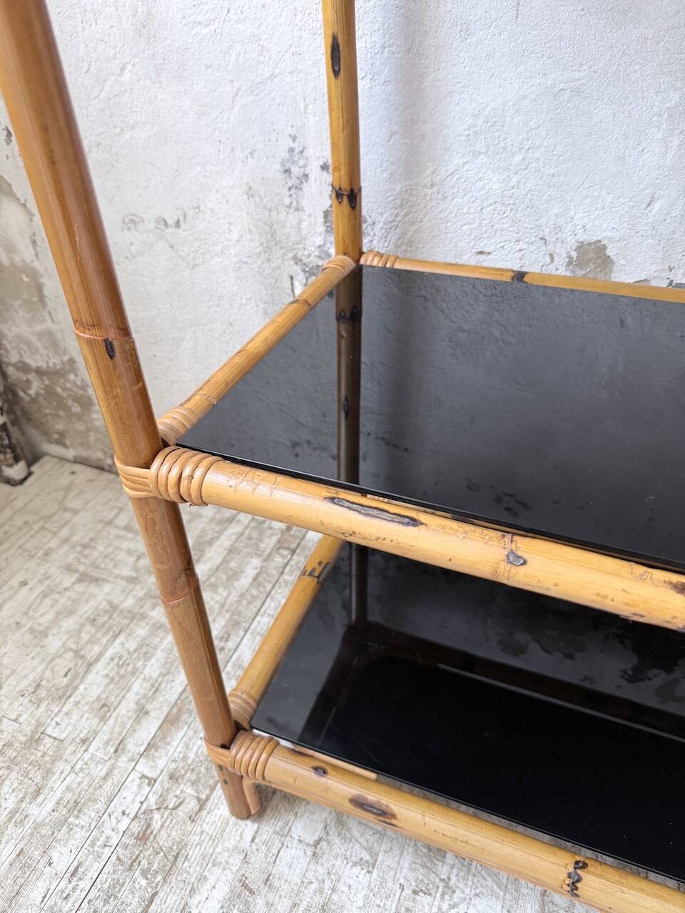 Rattan bookshelf and black glasses
