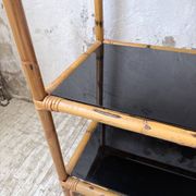 Rattan bookshelf and black glasses