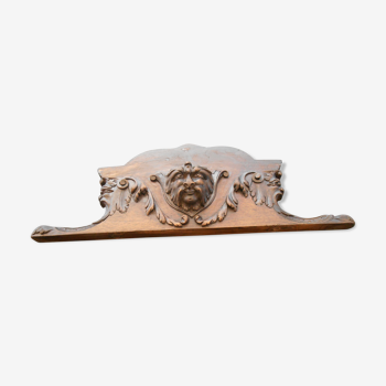 Old pediment with head