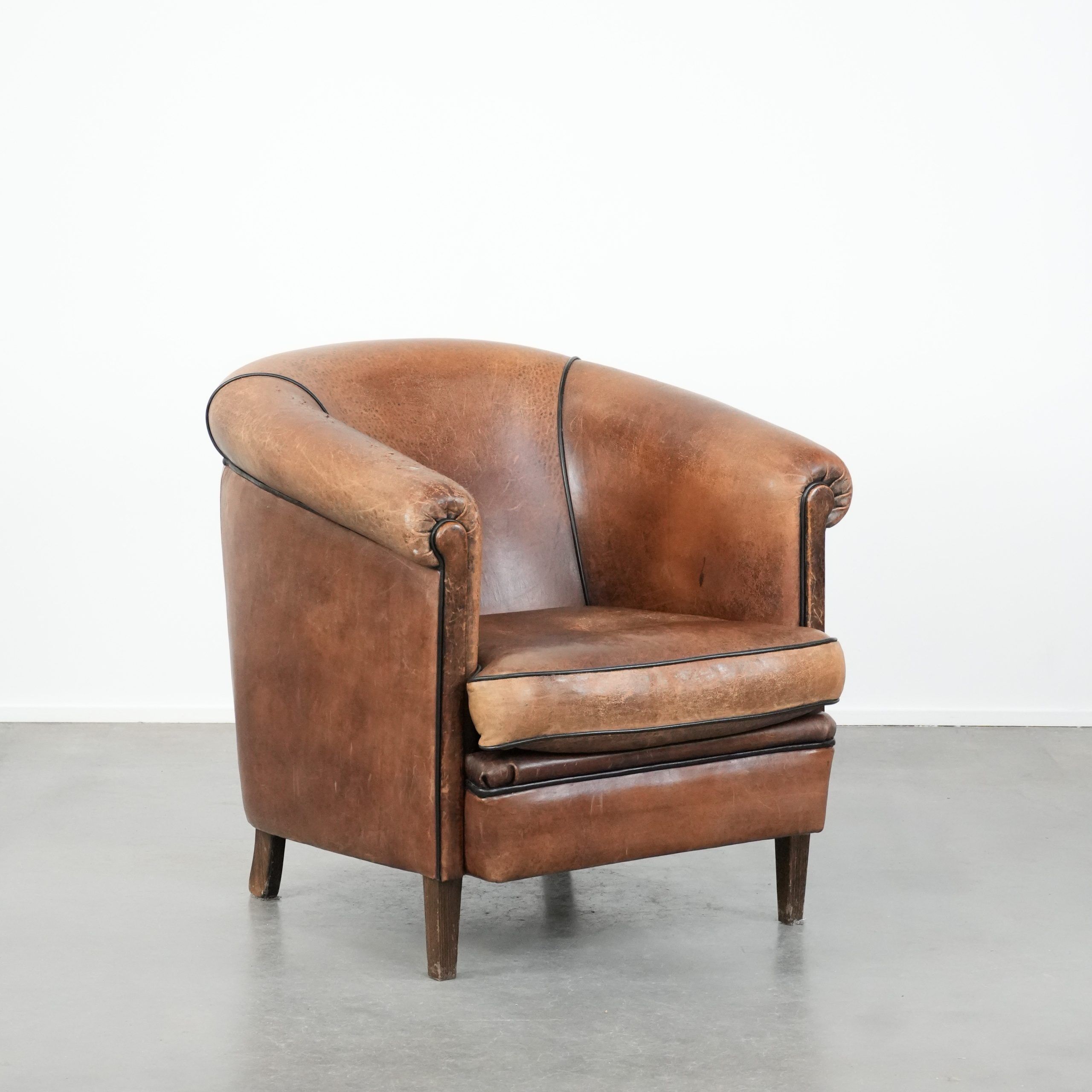 Sturdy vintage sheepskin club armchair with a beautiful patina