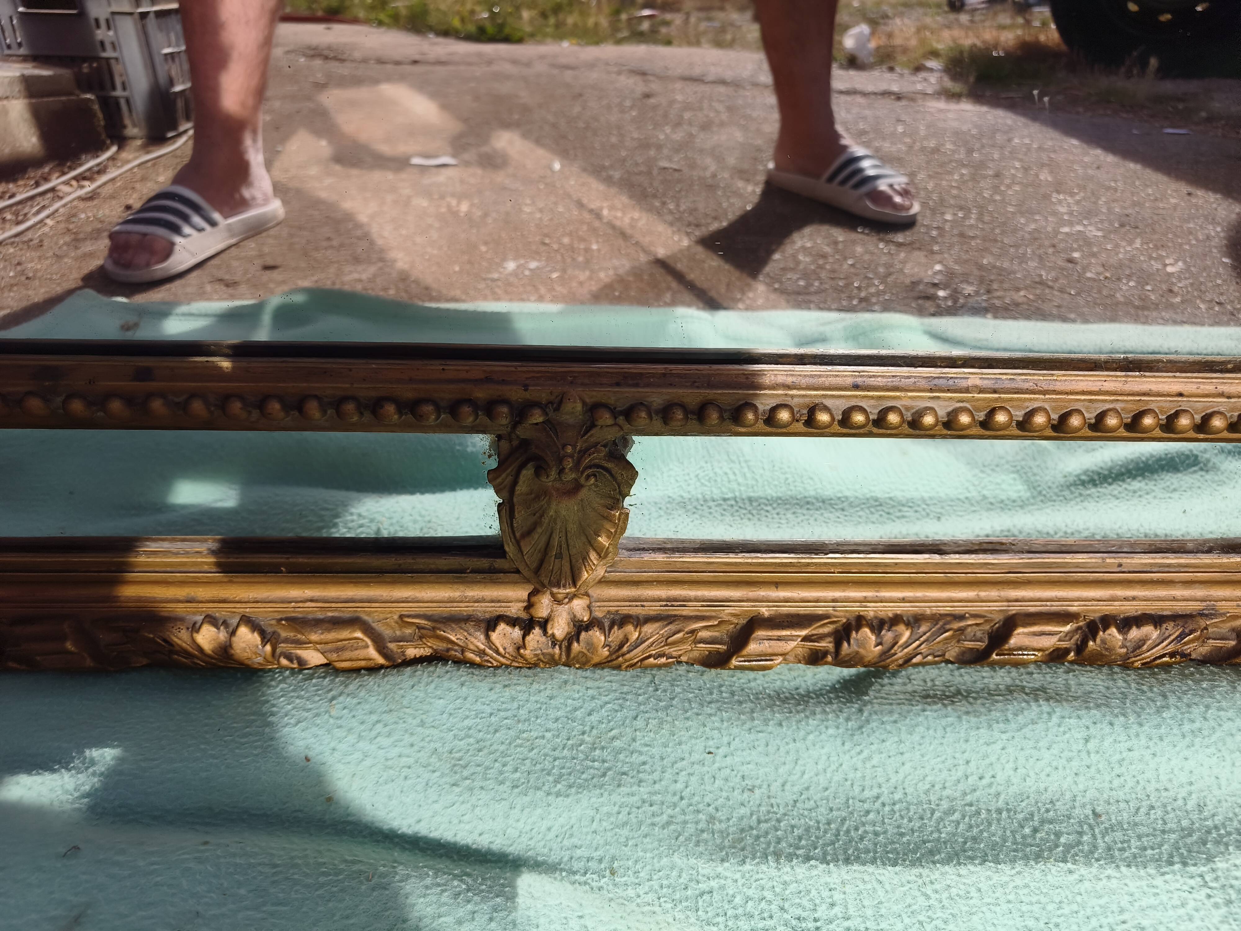 Large closed mirror, 19th century, wood and gilded stucco.