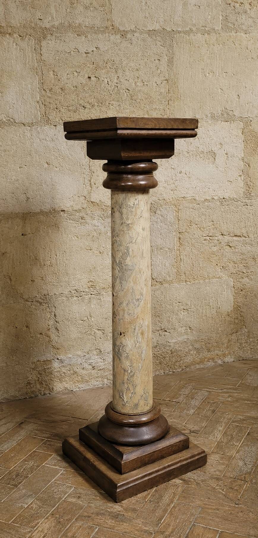 Wood and lacquer pedestal column table mimicking marble, 19th century.