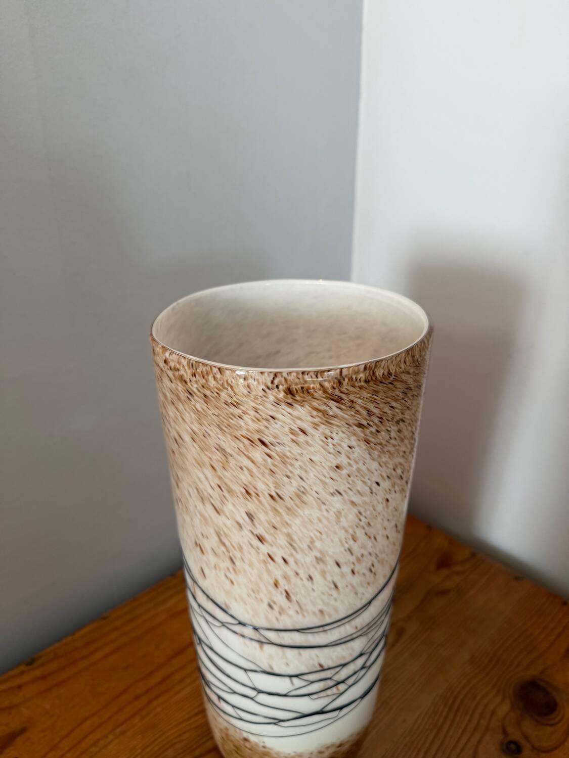 Large hand-blown glass vase in brown and beige.
