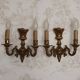 Pair of French baroque brass wall sconces with two branches, decorated with acanthus and wickerwork.