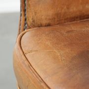 Sheepskin armchair with a beautiful vintage look and decorative nail finish