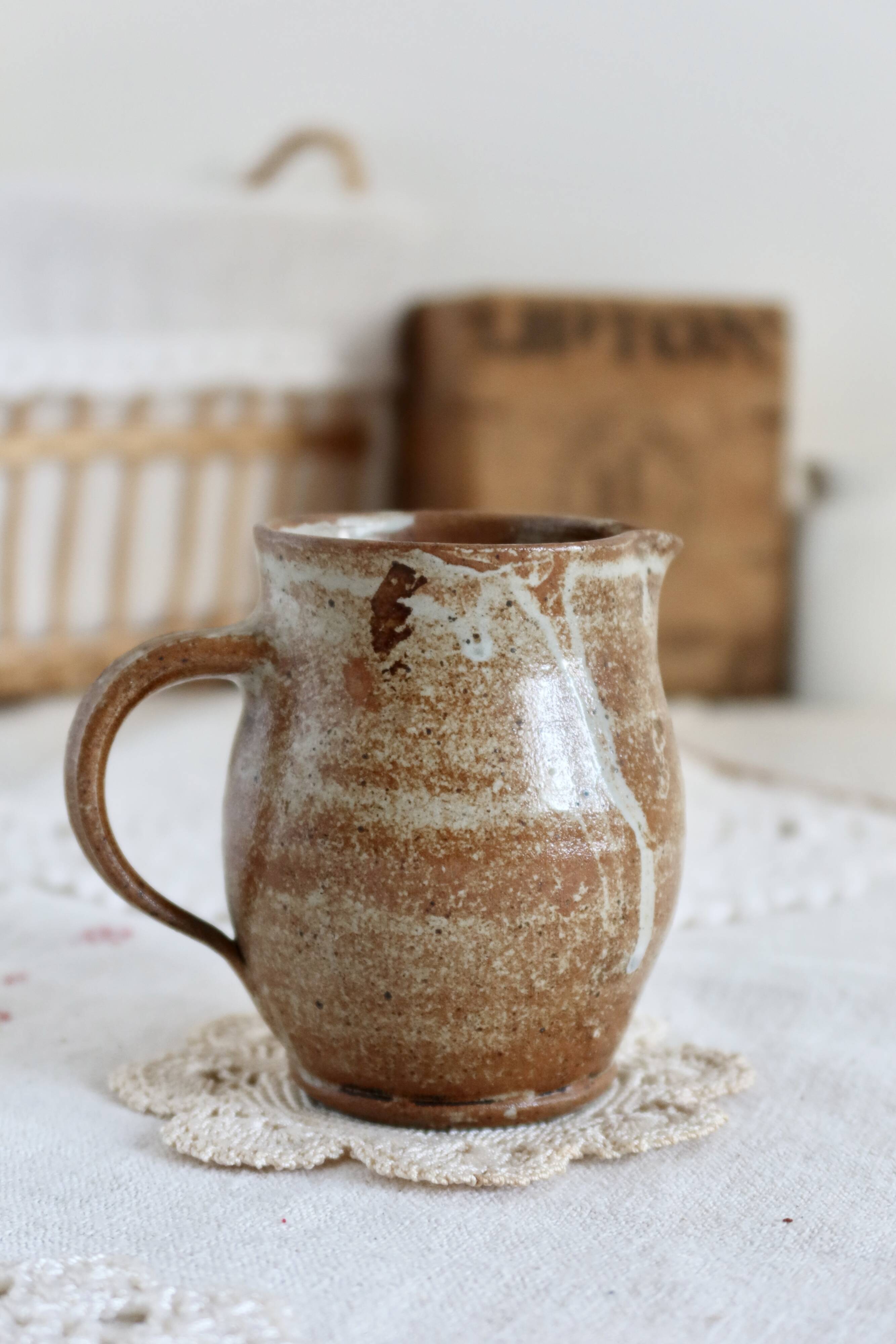 Small vintage hand turned ceramic milk jug with rustic glaze