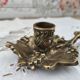 Hand-held candle holder called "cellar rat" in brass with vine leaf decoration