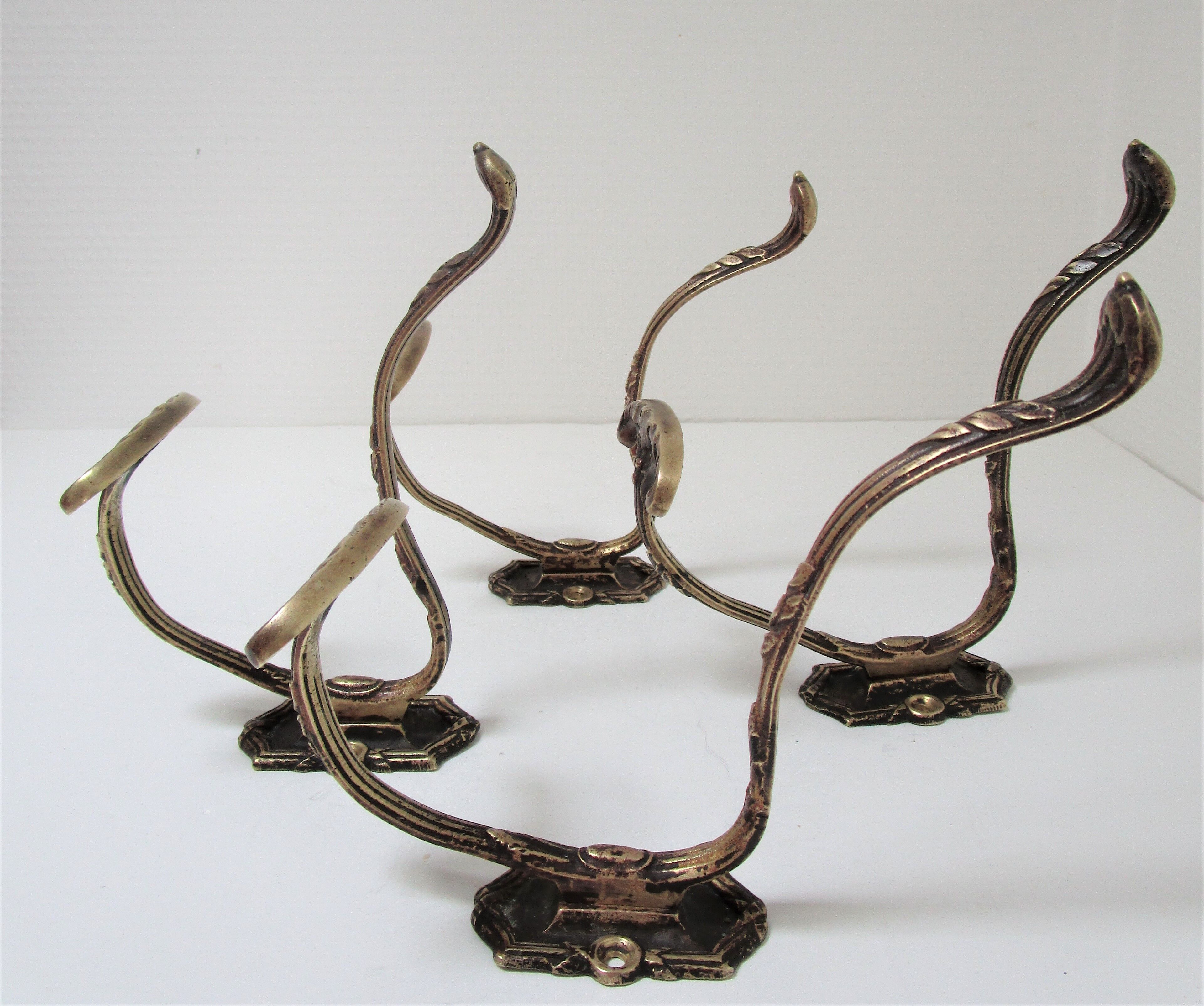 Four patères bronze patinated leafy décor early 20th century