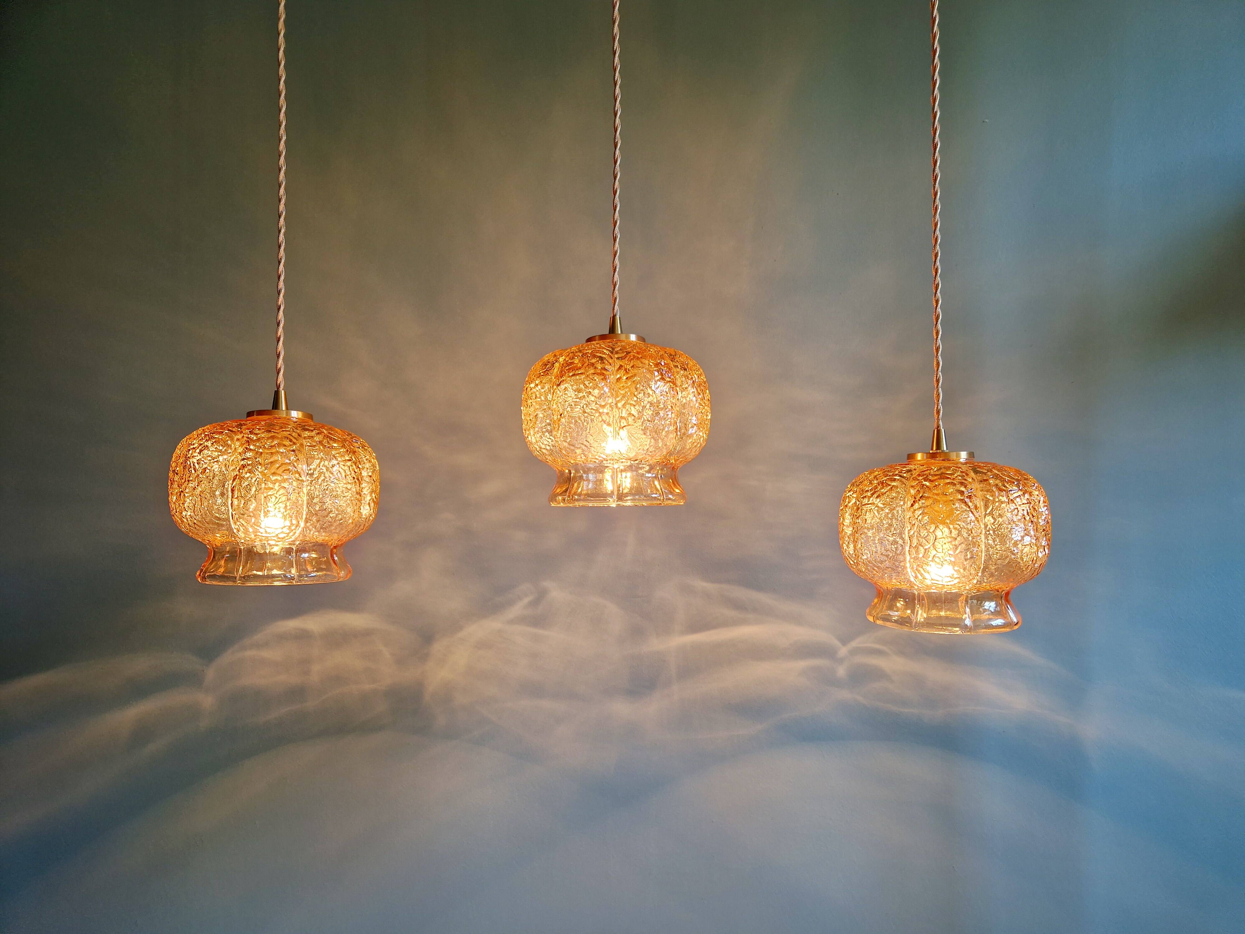 Vintage trio of amber glass pendants, 1960s-70s.