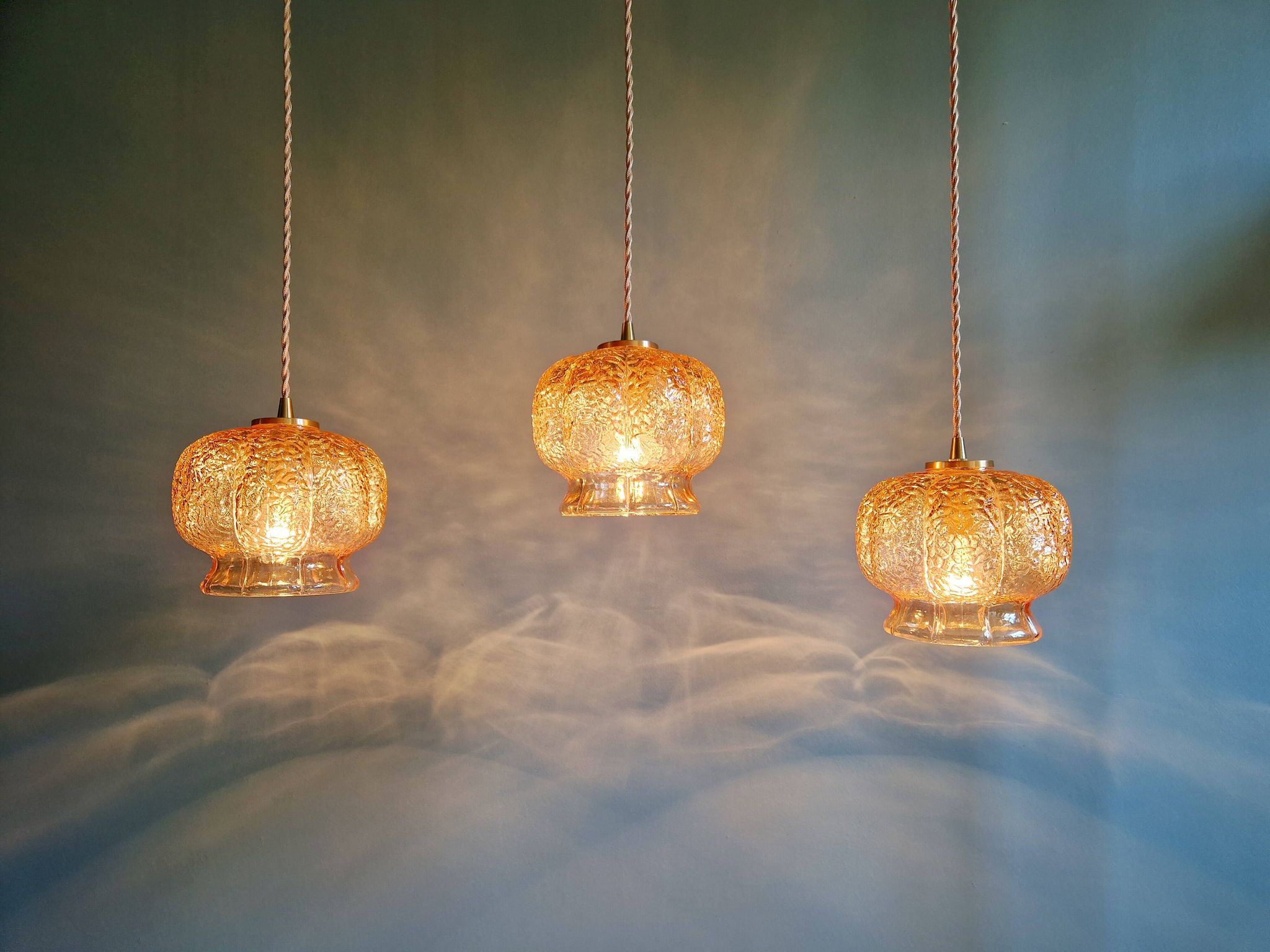 Vintage trio of amber glass pendants, 1960s-70s.